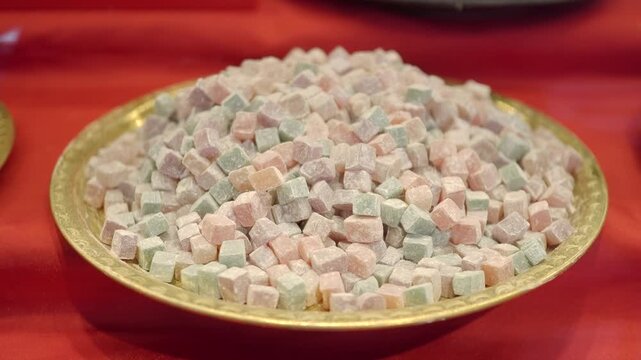 Colorful turkish delights are shown on a traditional plate