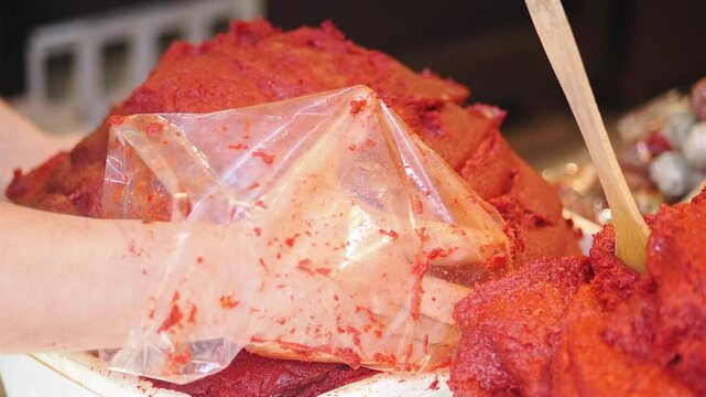 Making spicy red chili paste in a busy kitchen