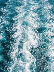 Fototapeta premium Foamy white wake trail behind a fast moving boat in deep blue ocean water with movement turbulence propeller navigation seascape daylight
