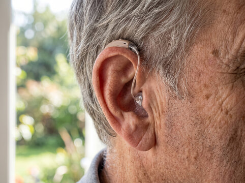 Close Up Of Senior Man Ear With In The Ear Hearing Aid
