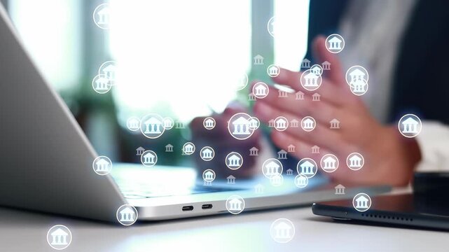 A person is using a laptop at a table. Various bank symbols float around the person, suggesting themes of finance and online banking. The setting has bright lighting.