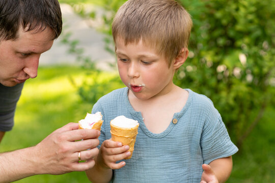 Father and Son Holding Ice Cream Cones Outdoors