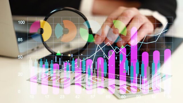A person works at a desk with a computer and financial documents. Colorful charts and graphs display numerical data and trends related to business performance.