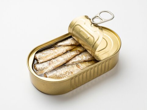 An opened oval tin can filled with sardines in oil on a white background. Canned seafood product.