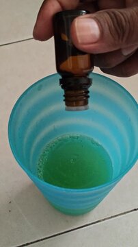 Adding Drops of Pine Essential Oil to Green Drink