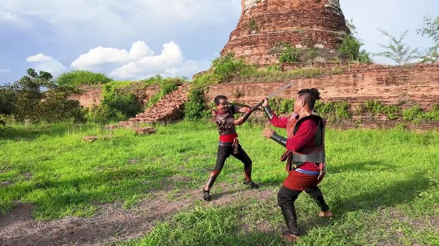 Thai Warriors Sword Fighting at Ayutthaya Ancient Ruins