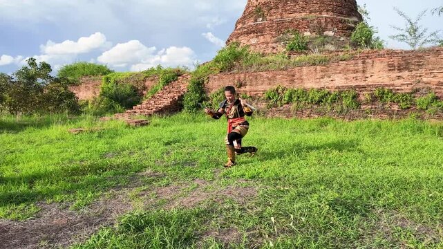 Thai Warrior in Traditional Armor Performing Sword Dance at Ayutthaya Ruins
