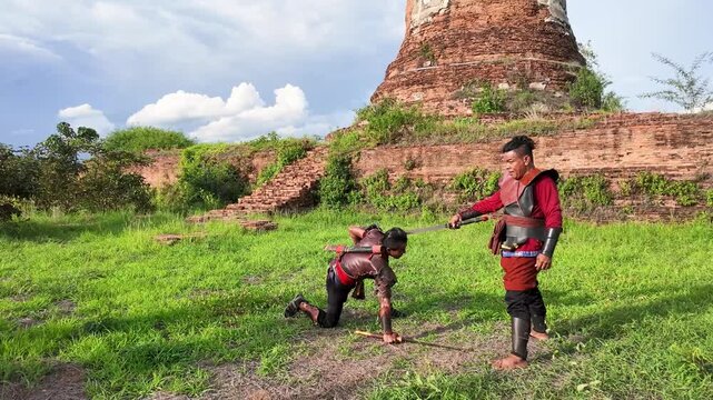 Thai Warriors Reenacting Ancient Sword Combat at Ayutthaya Ruins
