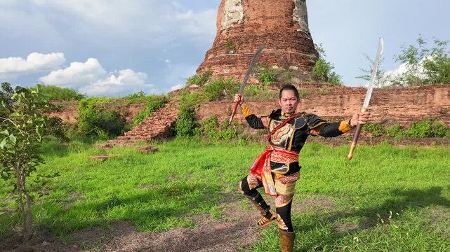 Thai Warrior in Traditional Armor Practicing Sword Fighting at Ayutthaya Ruins