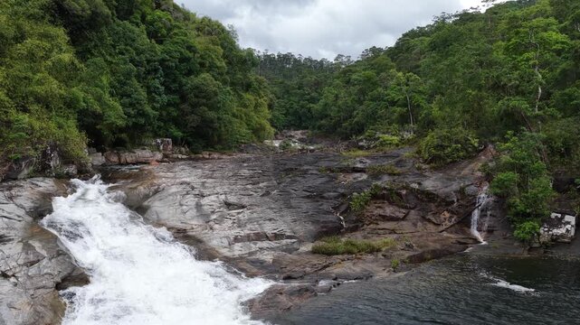 Low Aerial Drone Flight Continuing Up a Long Powerful Cascade in Chu Yang Sin National Park, Dak Lak, Vietnam, Following White Rushing Water Through Rugged Rocks and Dense Mountain Forest