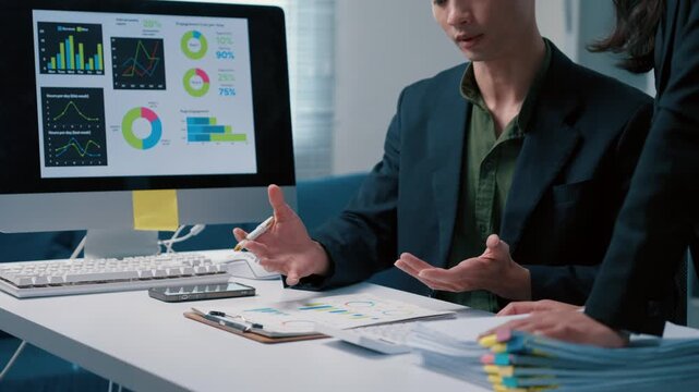 Business colleagues analyzing financial data charts in the office