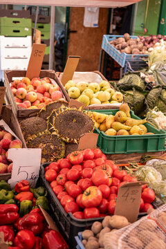 Fruits and vegetables at the benches of a grocery store of a local market. Vertical photo.