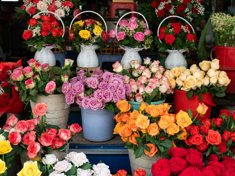 Beautiful assorted fresh flower bouquets and colorful roses displayed at local florist street shop
