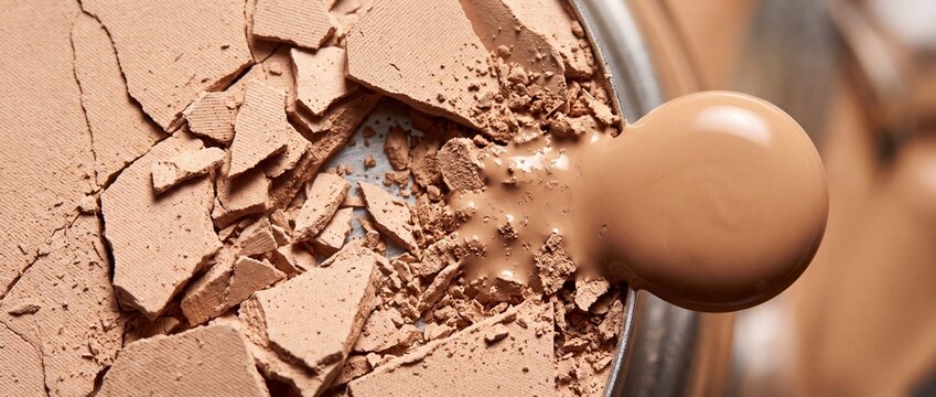 Crushed beige powder foundation with liquid drop, representing makeup product texture and application for beauty