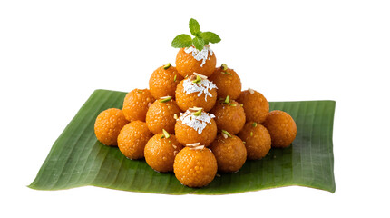 Naklejka premium A pyramid stack of delicious motichoor ladoo sweets served on a green banana leaf, isolated on transparent background