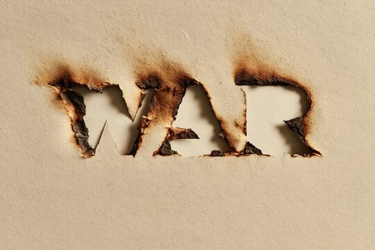 The word war burned into a piece of textured paper
