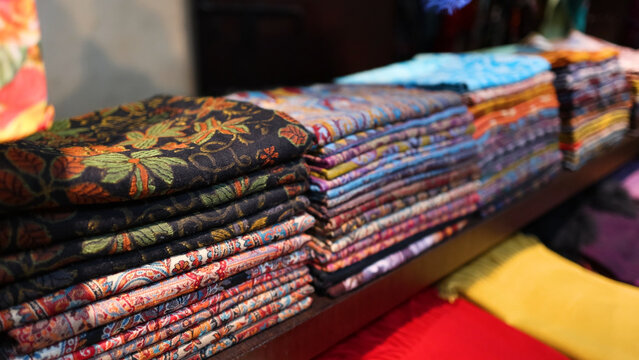Stacks of Colorful Traditional Arabic Fabrics on Display in Dubai