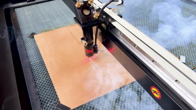 Laser cutting machine. The laser cuts the details. Automation and precision system. Modern industrial technology. Industrial laser engraving machine. Cnc laser head. 