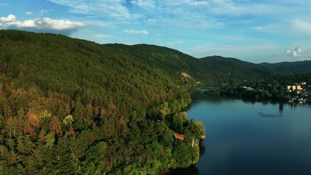 Aerial view of Pancharevo Lake surrounded by forested hills near Sofia, Bulgaria
