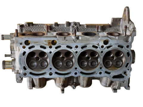 Metallic car engine cylinder head block showing internal combustion chambers and valves