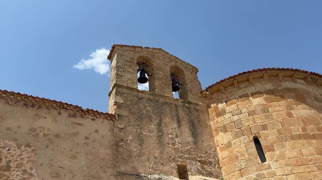 Romanesque church stone bell tower against a blue sky