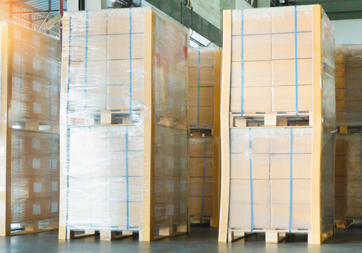 Bulk of Package Boxes Wrapped Plastic on Pallets. Storage Distribution Warehouse. Cartons, Cardboard Boxes. Supply Chain, Supplies Goods Shipment. Warehouse Shipping Logistics	