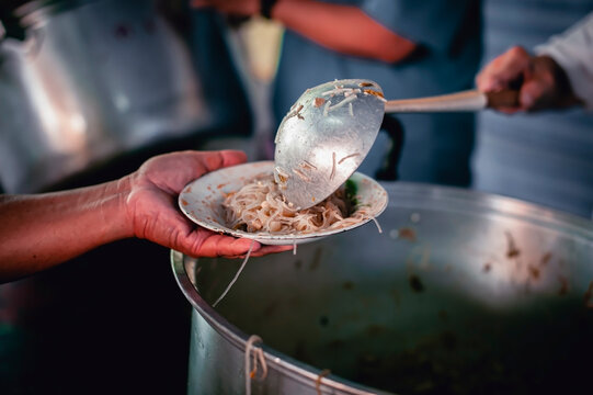 hands of the poor receive food from the donor's share , Feeding the poor to help and share