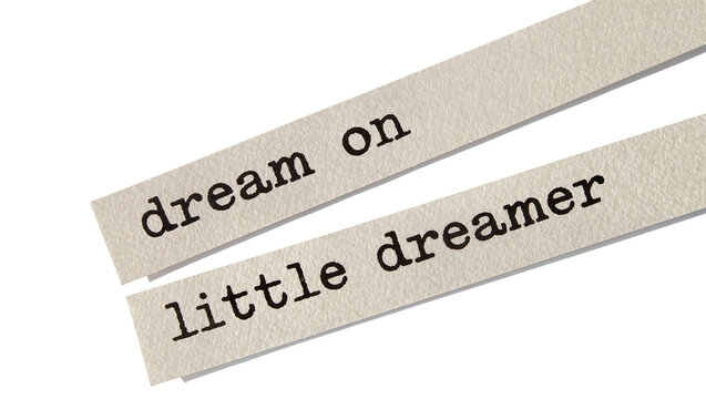 Two paper strips with typed text dream on and little dreamer , isolated on transparent background