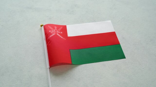 Oman flag close up on isolated background. Concept Omani country flag.