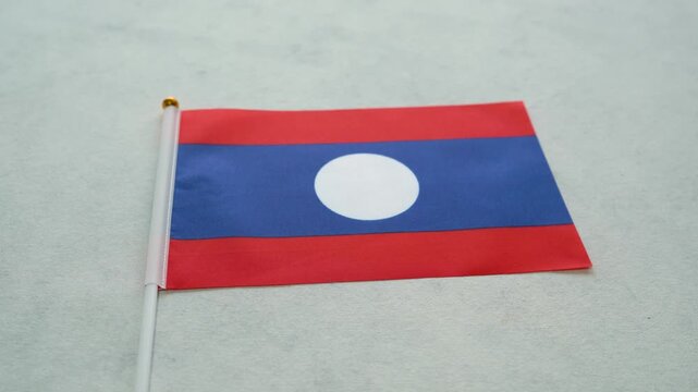 Laotian country flag close-up. Laos flag concept.