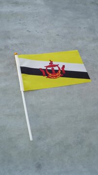 Bruneian country flag close-up. Brunei flag concept. Vertical shot.