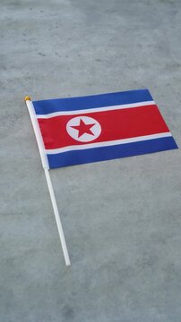 North Korea country flag. Vertical shot. North Korean flag with background.