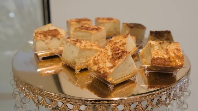 Small plates of creamy caramel flan are arranged for guests at a quinceanera reception dessert table