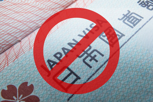 Entry ban, visa cancellation, visa ban, visa crossed out in red Visa in passport for world travel, Japan visa, tour, airport, customs, news, closed borders, nationality. Macro photo. High quality phot