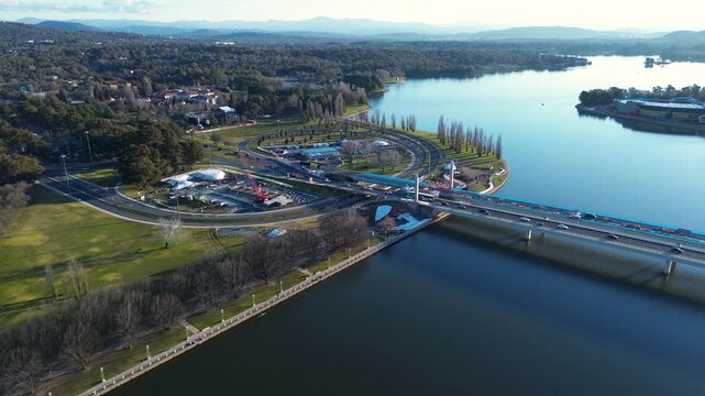 Drone aerial landscape of car vehicles and traffic travelling across the Commonwealth Avenue Bridge and waterfront near the Parliamentary Zone in Parkes Canberra ACT Australia transportation tourism