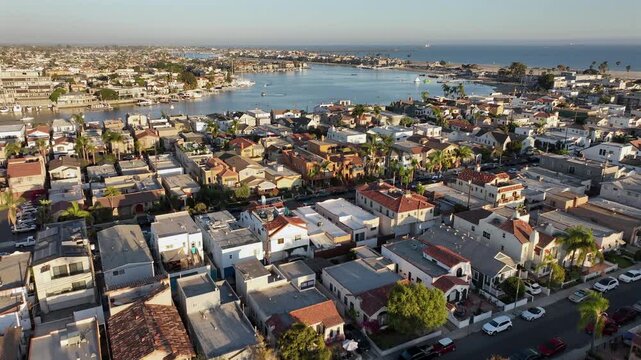 Drone perspective of Belmont Shore and the 2nd Street area at sunset, showcasing Horny Corner, surrounding residential and commercial buildings, busy streets