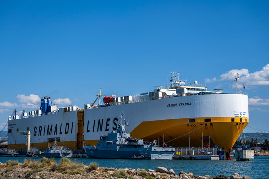 Koper, Slovenia - August 8, 2026: Slovenian patrol boat Triglav moored next to the large Grimaldi Lines car carrier Grande Spagna at the Port of Koper.