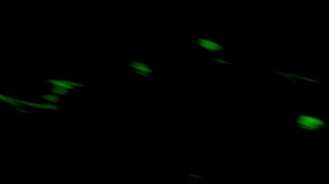 A dynamic stock motion graphic loop featuring vibrant green energy particles, wisps of flame, and glowing toxic sparks floating against a pitch-black background. Ideal for sci-fi VFX overlay, cyber ma