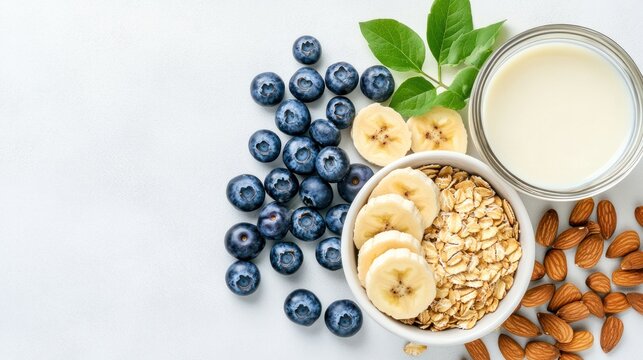 Healthy Breakfast Ingredients: A vibrant arrangement of fresh blueberries, sliced bananas, rolled oats, almonds, and a glass of milk, promising a nutritious and delicious start to the day.