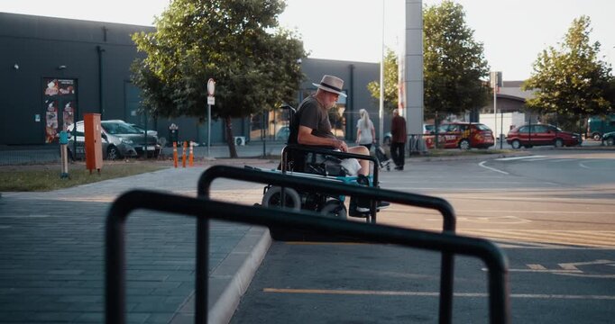 Senior man in an electric wheelchair uses an access ramp in the city, showing independent mobility, accessibility and active everyday life.