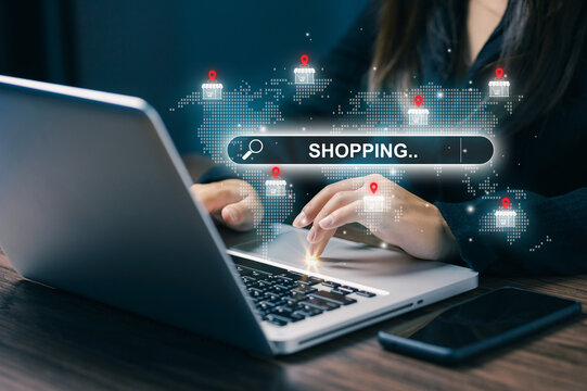 Woman using laptop with global online shopping search interface, digital store location icons and world map, illustrating ecommerce, retail technology and worldwide marketplace access.