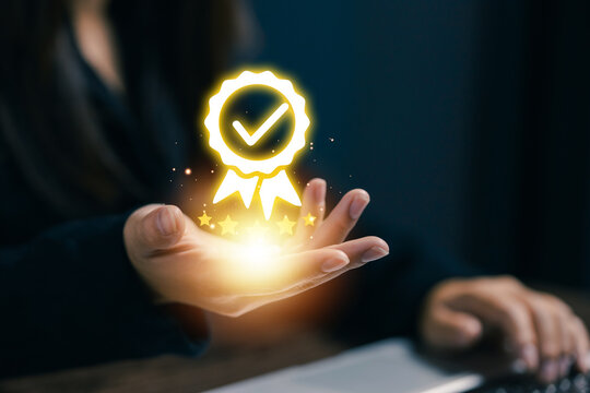Businesswoman presenting a glowing quality assurance badge with check mark and star rating, symbolizing certification, customer trust, service excellence and verified business standards.