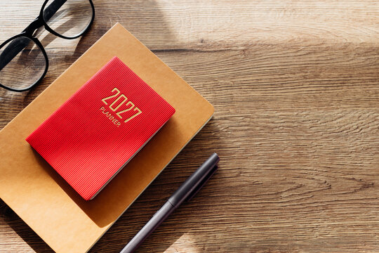 Planning 2027 new year goals with a red planner