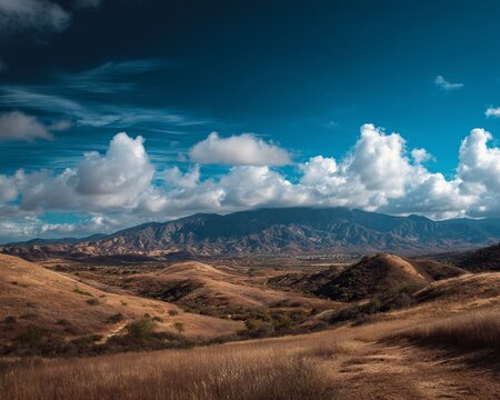 Vast California Landscape with Rolling Hills and Dramatic Sky.