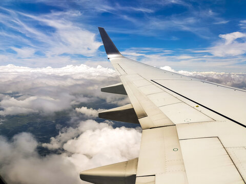 Scenic views from an airplane window, featuring blue skies, expanding clouds, landing on the runway, and mid-flight moments.