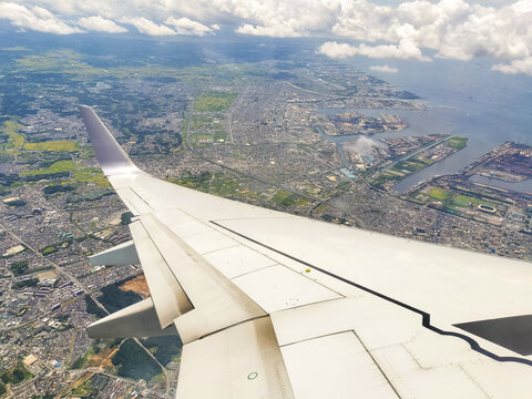 Scenic views from an airplane window, featuring blue skies, expanding clouds, landing on the runway, and mid-flight moments.