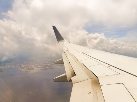 Scenic views from an airplane window, featuring blue skies, expanding clouds, landing on the runway, and mid-flight moments.