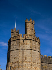 Eagle Tower of Caernarfon Castle against a deep blue sky, Wales, UK. © Cavan