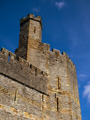 Tower of Caernarfon Castle against a deep blue sky, Wales, UK. © Cavan