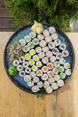 Large assorted sushi maki platter on a wooden table © Cavan